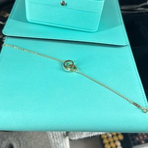 Tiffany & Co. Gold Interlocking Rings Bracelet on Tiffany Blue